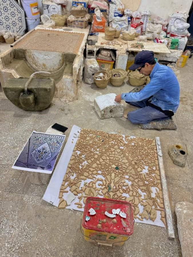 A craftsman assembling zellige
